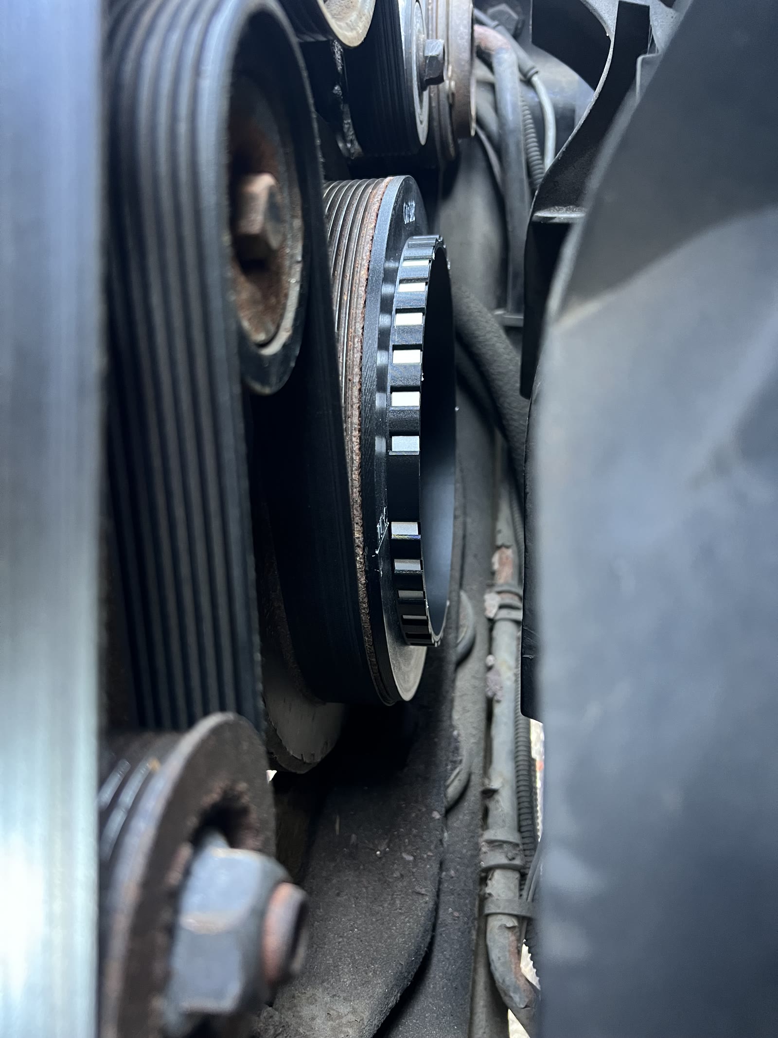 The crank pickup target seated on the crank damper of the engine, ready to read